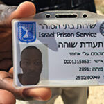 Mutassim Ali shows Prison ID at Holot Prison, Negev Desert